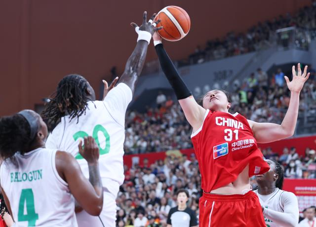(260812) -- FOSHAN, Aug. 12, 2026 (Xinhua) -- Jia Saiqi (R) of China vies for the ball with Murjanatu Musa (2nd L) of Nigeria during a friendly women's basketball match in Foshan, south China's Guangdong province, Aug. 12, 2026. (Xinhua/Deng Hua)
