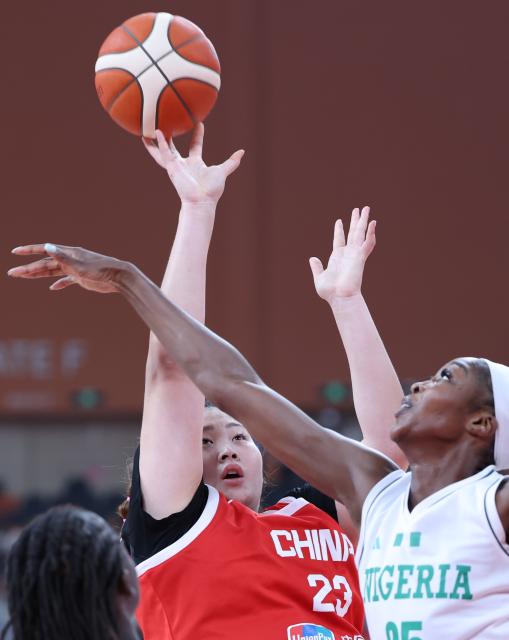 (260812) -- FOSHAN, Aug. 12, 2026 (Xinhua) -- Liu Yutong (L) of China shoots the ball against Victoria Macaulay of Nigeria during a friendly women's basketball match in Foshan, south China's Guangdong province, Aug. 12, 2026. (Xinhua/Deng Hua)