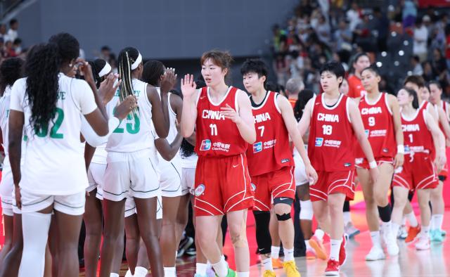 (260812) -- FOSHAN, Aug. 12, 2026 (Xinhua) -- Players of China (R) and Nigeria greet each other after a friendly women's basketball match in Foshan, south China's Guangdong province, Aug. 12, 2026. (Xinhua/Deng Hua)