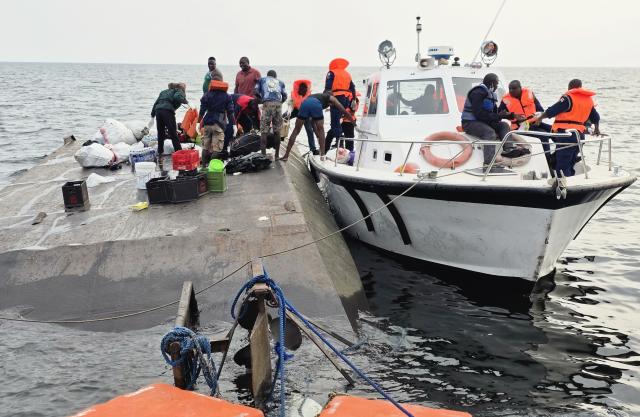 (260812) -- HARARE, Aug. 12, 2026 (Xinhua) -- Photo taken with a mobile phone shows rescuers conducting search and rescue operations at the site of a boat capsize on Lake Kariba in Mashonaland West Province, Zimbabwe, on August 12, 2026. Zimbabwean President Emmerson Mnangagwa on Wednesday declared a state of disaster following a boat capsize in Lake Kariba, as police confirmed the death toll from the tragedy had risen to 44. (Str/Xinhua)
