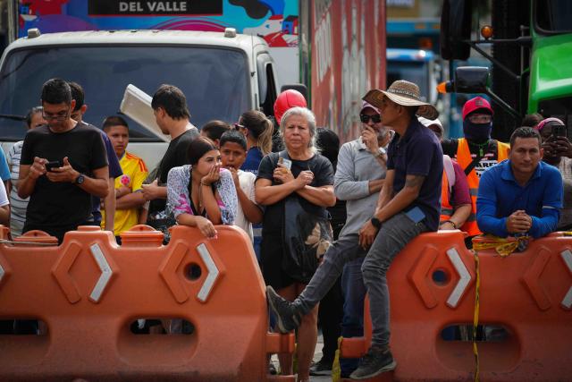 (260812) -- CALI, Aug. 12, 2026 (Xinhua) -- People wait for news of survivors after an earthquake in Cali, Colombia, Aug. 12, 2026. The death toll from Monday's 7.4-magnitude earthquake in western Colombia has risen to 241, with 3,771 others injured, Colombian media reported Wednesday, citing figures from the National Unit for Disaster Risk Management. (Photo by Andres Moreno/Xinhua)