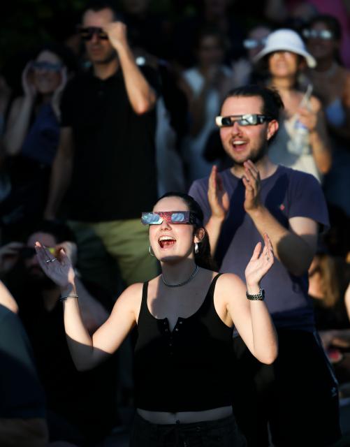 (260812) -- PARIS, Aug. 12, 2026 (Xinhua) -- People observe a partial solar eclipse in Paris, France, Aug. 12, 2026. (Xinhua/Wu Huiwo)
