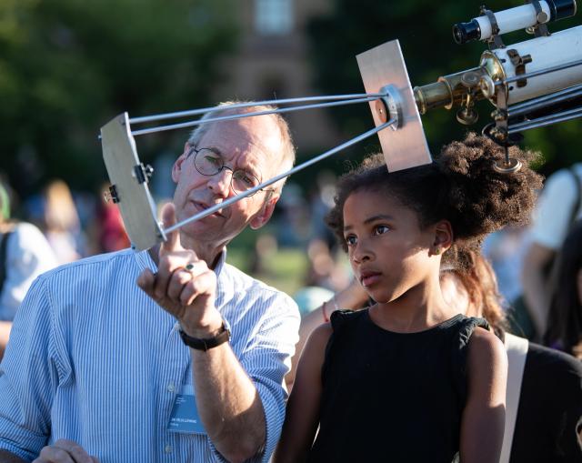 (260812) -- BERLIN, Aug. 12, 2026 (Xinhua) -- An expert (L) introduces an observation equipment at the Zeiss Grand Planetarium in Berlin, Germany, Aug. 12, 2026. The Long Night of Astronomy event was held here on Wednesday, inviting the public to observe the solar eclipse and experience the fascination of astronomy. (Xinhua/Zhang Haofu)