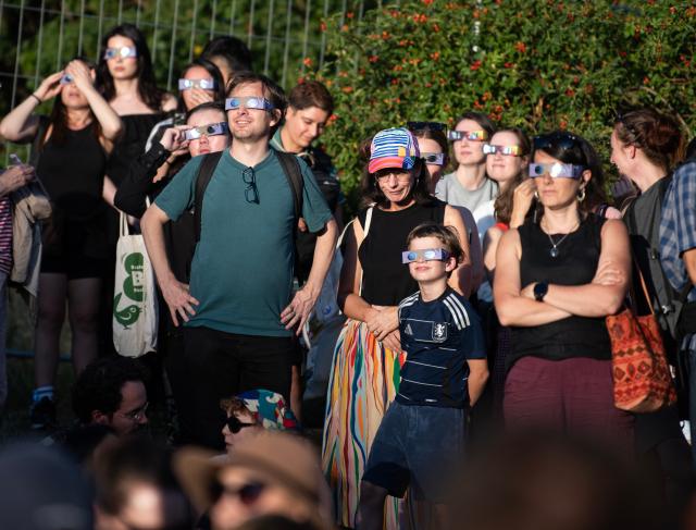 (260812) -- BERLIN, Aug. 12, 2026 (Xinhua) -- People observe the partial solar eclipse at the Zeiss Grand Planetarium in Berlin, Germany, Aug. 12, 2026. The Long Night of Astronomy event was held here on Wednesday, inviting the public to observe the solar eclipse and experience the fascination of astronomy. (Xinhua/Zhang Haofu)