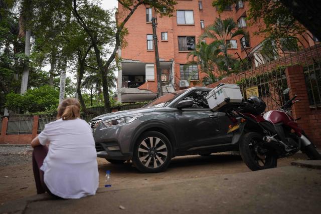(260812) -- CALI, Aug. 12, 2026 (Xinhua) -- A women sits outside of a damaged building in an earthquake in Cali, Colombia on Aug. 12, 2026. The death toll from Monday's 7.4-magnitude earthquake in western Colombia has risen to 241, with 3,771 others injured, Colombian media reported Wednesday, citing figures from the National Unit for Disaster Risk Management. (Photo by Andres Moreno/Xinhua)
