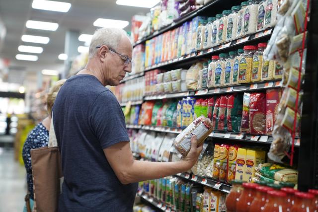 (260813) -- NEW YORK, Aug. 13, 2026 (Xinhua) -- A customer reads product information at a store in New York, the United States, on Aug. 12, 2026. The U.S. consumer price index (CPI) rose 3.4 percent year on year in July, slightly lower than 3.5 percent in June, according to data released by the U.S. Bureau of Labor Statistics (BLS) on Wednesday. (Xinhua/Zhang Fengguo)