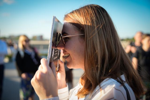 (260813) -- WARSAW, Aug. 13, 2026 (Xinhua) -- A woman uses solar eclipse glasses to observe the partial solar eclipse at the Copernicus Science Center in Warsaw, Poland, Aug. 12, 2026. (Photo by Jaap Arriens/Xinhua)