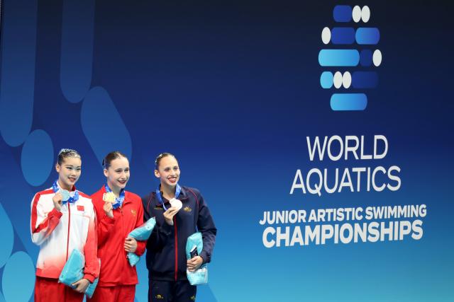 (260813) -- BUDPAEST, Aug. 13, 2026 (Xinhua) -- Gold medalist Aleksandra Zavialova (C) of Russia, silver medalist He Zhien (L) of China and bronze medalist Daniela Suarez Fernandez of Spain pose for a photo during the awarding ceremony for the Women's Solo Technical Event of the World Aquatics Junior Artistic Swimming Championships in Budapest, Hungary, on Aug. 12, 2026. (Photo by Attila Volgyi/Xinhua)