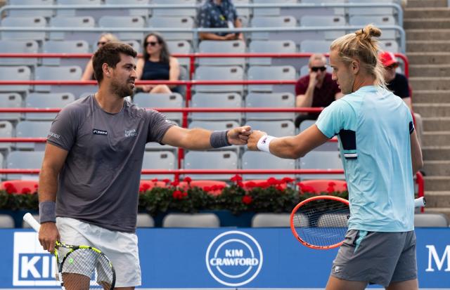 (260813) -- MONTREAL, Aug. 13, 2026 (Xinhua) -- Orlando Luz/Rafael Matos (R) of Brazil react during the men's doubles semifinal match between Orlando Luz/Rafael Matos of Brazil and Francisco Cerundolo/Tomas Martin Etcheverry of Argentina at the 2026 National Bank Open tennis tournament in Montreal, Canada, Aug. 12, 2026. (Photo by Li Haitao/Xinhua)