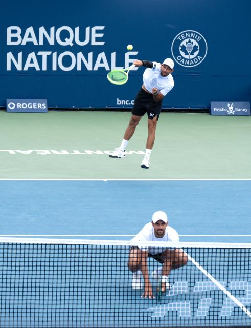 (260813) -- MONTREAL, Aug. 13, 2026 (Xinhua) -- Marcelo Arevalo(top)/Mate Pavic compete during the men's doubles semifinal match between Marcelo Arevalo(El Salvador)/Mate Pavic(Croatia) and Theo Arribage/Albano Olivetti of France at the 2026 National Bank Open tennis tournament in Montreal, Canada, Aug. 12, 2026. (Photo by Li Haitao/Xinhua)