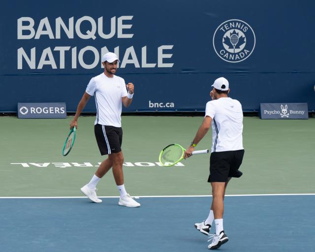 (260813) -- MONTREAL, Aug. 13, 2026 (Xinhua) -- Marcelo Arevalo/Mate Pavic (L) react during the men's doubles semifinal match between Marcelo Arevalo(El Salvador)/Mate Pavic(Croatia) and Theo Arribage/Albano Olivetti of France at the 2026 National Bank Open tennis tournament in Montreal, Canada, Aug. 12, 2026. (Photo by Li Haitao/Xinhua)