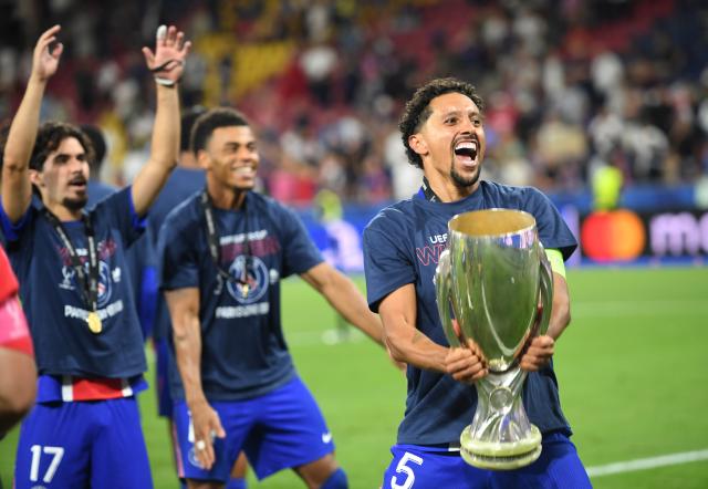 (260813) -- SALZBURG, Aug. 13, 2026 (Xinhua) -- Marquinhos (R) of Paris Saint-Germain celebrates with the trophy after the 2026 UEFA Super Cup final football match between Paris Saint-Germain of France and Aston Villa of England in Salzburg, Austria, Aug. 12, 2026. (Xinhua/He Canling)