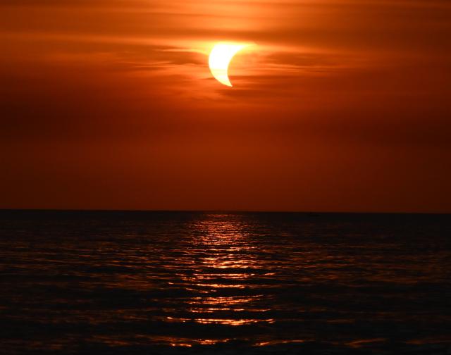 (260813) -- LADISPOLI, Aug. 13, 2026 (Xinhua) -- This photo taken on Aug. 12, 2026 shows a partial solar eclipse over the sea in Ladispoli, Italy. (Photo by Alberto Lingria/Xinhua)