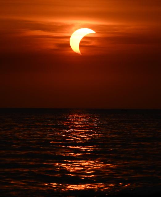 (260813) -- LADISPOLI, Aug. 13, 2026 (Xinhua) -- This photo taken on Aug. 12, 2026 shows a partial solar eclipse over the sea in Ladispoli, Italy. (Photo by Alberto Lingria/Xinhua)