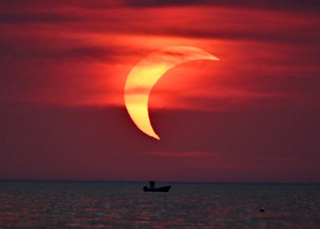 (260813) -- LADISPOLI, Aug. 13, 2026 (Xinhua) -- This photo taken on Aug. 12, 2026 shows a partial solar eclipse over the sea in Ladispoli, Italy. (Photo by Alberto Lingria/Xinhua)