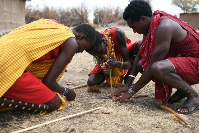 (260813) -- NAROK, Aug. 13, 2026 (Xinhua) -- Maasai villagers demonstrate fire-making by friction at a village around the Maasai Mara National Reserve in Narok, Kenya, on Aug. 12, 2026.
  The Maasai, one of the major tribes in Kenya, are still living a nomadic lifestyle. As local tourism develops, Maasai people have opened their villages to tourists to increase their income. (Xinhua/Liu Qiong)