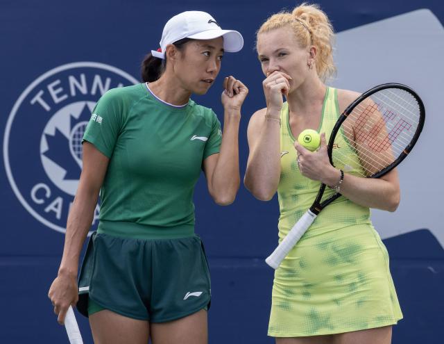 (260813) -- TORONTO, Aug. 13, 2026 (Xinhua) -- Katerina Siniakova/Zhang Shuai (L) talk to each other during the women's doubles semifinal match between Katerina Siniakova (the Czech Republic)/Zhang Shuai (China) and Tereza Mihalikova (Slovakia)/Olivia Nicholls (Britain) at the 2026 National Bank Open tennis tournament in Toronto, Canada, Aug. 12, 2026. (Photo by Zou Zheng/Xinhua)