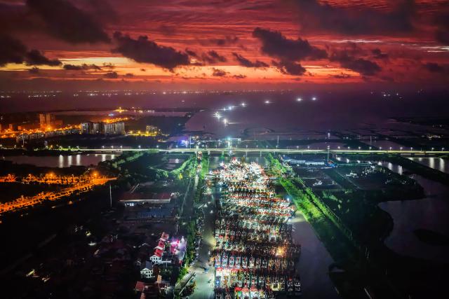 (260813) -- BEIJING, Aug. 13, 2026 (Xinhua) -- An aerial drone photo taken on Aug. 12, 2026 shows fishing boats preparing to depart for the Yellow Sea after a fishing ban was lifted in Lianyungang City, east China's Jiangsu Province. Special licensed fishing vessels set out to the Yellow Sea as the summer fishing moratorium was partially lifted on Aug. 12, which had been postponed for a week due to impacts of Typhoon Dolphin. (Photo by Wang Jianmin/Xinhua)