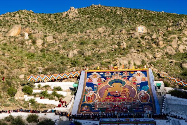 (260813) -- BEIJING, Aug. 13, 2026 (Xinhua) -- People view an enormous thangka painting of Buddha at the Drepung Monastery in Lhasa, southwest China's Xizang Autonomous Region, Aug. 12, 2026.
  Celebrations marking the traditional Shoton Festival began in Lhasa on Wednesday. (Xinhua/Jiang Fan)