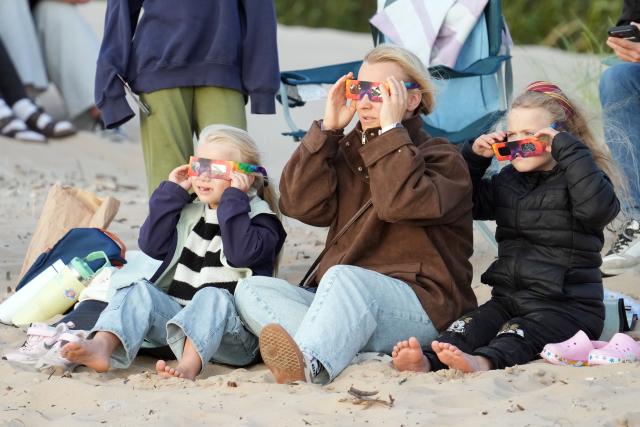 (260813) -- RIGA, Aug. 13, 2026 (Xinhua) -- People watch a partial solar eclipse over the Baltic Sea in Riga, Latvia, on Aug. 12, 2026. (Photo by Edijs Palens/Xinhua)