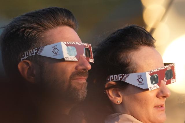 (260813) -- RIGA, Aug. 13, 2026 (Xinhua) -- People watch a partial solar eclipse over the Baltic Sea in Riga, Latvia, on Aug. 12, 2026. (Photo by Edijs Palens/Xinhua)