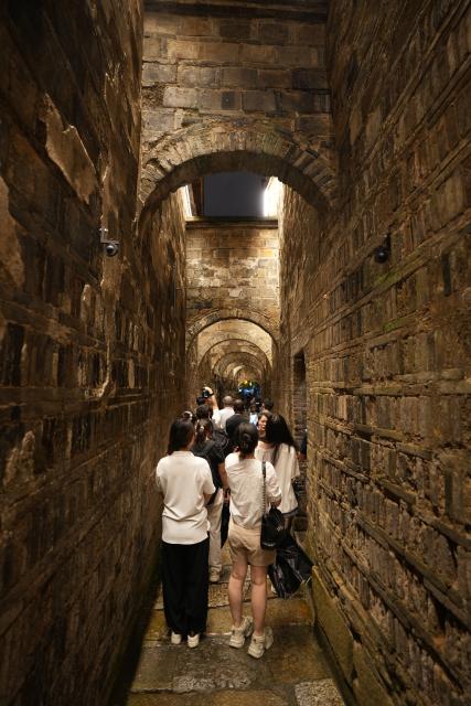 (260813) -- YIYANG, Aug. 13, 2026 (Xinhua) -- Tourists view ancient architecture within a historic and cultural district in Yiyang City, central China's Hunan Province, on Aug. 12, 2026.
  The old district dating back to the Ming and Qing dynasties (1368-1911) is home to 41 cultural heritage sites. 
  As the nighttime economy continues to gain momentum during the summer vacation, the district is attracting large numbers of visitors with its diverse tourism offerings. The passenger flow at night now accounts for 65 percent of the district's total daily visits, while nighttime spending makes up 70 percent of total consumption. (Xinhua/Dai Mingxuan)
