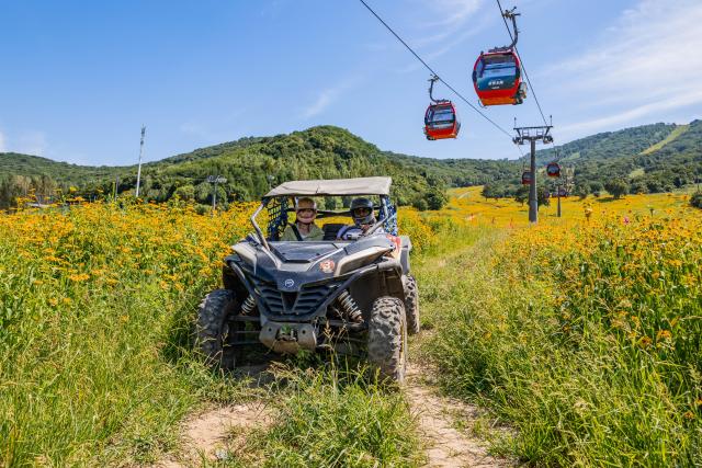 (260813) -- JILIN, Aug. 13, 2026 (Xinhua) -- Tourists drive an off-road vehicle at the Lake Songhua Resort in Jilin City, northeast China's Jilin Province, Aug. 12, 2026. The Lake Songhua Resort, located in Jilin City, is a national-level ski tourism resort. In recent years, relying on its mountain resources, the resort has extended operation in other seasons except for winter, attracting tourists with natural scenery and mountain sports. 
   Since April 25 this year, the resort has received a total of 200,000 visitors, a year-on-year growth of 20 percent. From popular destination in winter to year-round operation, the tourism potential of the resort is being fully tapped, promoting the high-quality development of the local cultural and tourism industry. (Xinhua/Zhang Nan)