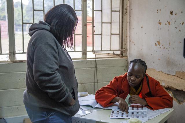 (260813) -- LUSAKA, Aug. 13, 2026 (Xinhua) -- A staff member checks a voter's identity at a polling station in Lusaka, Zambia, on Aug. 13, 2026.
  Zambia held general elections on Thursday, with about 8.7 million registered voters casting ballots for president, National Assembly members and local representatives. (Photo by Martin Mbangweta/Xinhua)