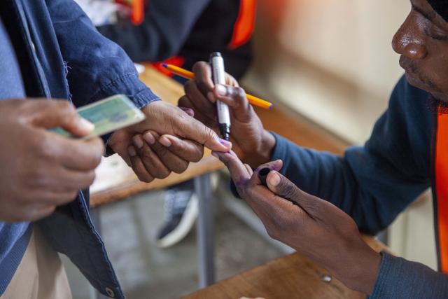 (260813) -- LUSAKA, Aug. 13, 2026 (Xinhua) -- A staff member inks a mark on a voter's thumb for preventing multiple voting at a polling station in Lusaka, Zambia, on Aug. 13, 2026.
  Zambia held general elections on Thursday, with about 8.7 million registered voters casting ballots for president, National Assembly members and local representatives. (Photo by Martin Mbangweta/Xinhua)
