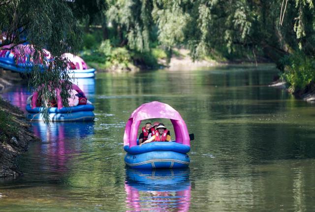 (260813) -- ZHAOTONG, Aug. 13, 2026 (Xinhua) -- Tourists from southwest China's Sichuan Province enjoy rafting in Xunlong Village, Sayu Town, Zhaoyang District, Zhaotong City, southwest China's Yunnan Province, Aug. 13, 2026. In recent years, Zhaoyang District in Zhaotong City has leveraged its cool and pleasant climate to boost the in-depth sojourn tourism experience as a summer retreat.
   The local government has introduced special support policies for summer retreat tourism, optimizing services including dining, lodging, transportation, sightseeing, shopping, and entertainment. (Xinhua/Chen Xinbo)