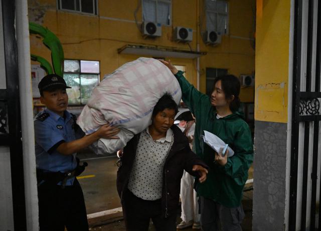 (260813) -- LUOHE, Aug. 13, 2026 (Xinhua) -- An evacuated resident (C) arrives at a temporary shelter in Beiwudu Town of Wuyang County, Luohe, central China's Henan Province, Aug. 13, 2026. Thousands of people have been evacuated in central China's Henan Province after days of torrential rain swelled rivers and triggered a levee breach, local authorities said Thursday.
  In Luohe City, more than 4,500 people from 10 villages were evacuated amid rising concerns over potential river flooding.
  From Monday afternoon to Wednesday afternoon, the city recorded an average rainfall of 270.1 millimeters, with a peak of 434.2 millimeters, prompting authorities to activate the highest-level flood control emergency response. (Xinhua/Hao Yuan)