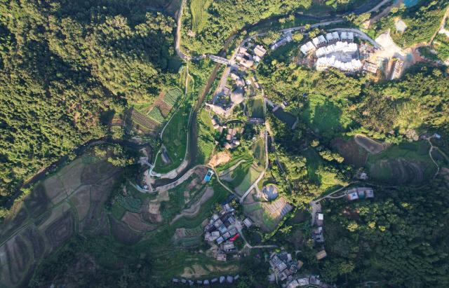 (260813) -- HAIKOU, Aug. 13, 2026 (Xinhua) -- An aerial drone photo taken on July 23, 2026 shows a view of Maona Village in Wuzhishan City, south China's Hainan Province. Hainan is stepping up with efforts to build a world-class destination for international tourism and consumption as a key component of the Hainan Free Trade Port, and to probe for a new path towards high-quality development in its tourism-led consumer economy with distinctive local characteristics. 
   Hainan is projected to annually receive 154 million counts of domestic and international visits by 2030, along with tourism-related revenue of 363 billion yuan (about 53.83 billion U.S. dollars). (Xinhua/Yang Guanyu)