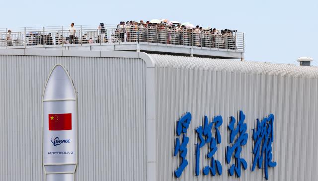 (260813) -- HAIKOU, Aug. 13, 2026 (Xinhua) -- Tourists watch a rocket launch at a viewing platform in Longlou Town, Wenchang, south China's Hainan Province, July 10, 2026. Hainan is stepping up with efforts to build a world-class destination for international tourism and consumption as a key component of the Hainan Free Trade Port, and to probe for a new path towards high-quality development in its tourism-led consumer economy with distinctive local characteristics. 
   Hainan is projected to annually receive 154 million counts of domestic and international visits by 2030, along with tourism-related revenue of 363 billion yuan (about 53.83 billion U.S. dollars). (Xinhua/Yang Guanyu)