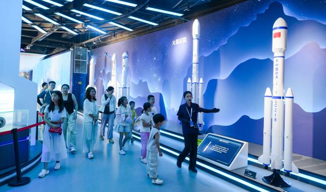 (260813) -- HAIKOU, Aug. 13, 2026 (Xinhua) -- Tourists visit Wenchang Spaceflight Science Center in Wenchang, south China's Hainan Province, July 24, 2026. Hainan is stepping up with efforts to build a world-class destination for international tourism and consumption as a key component of the Hainan Free Trade Port, and to probe for a new path towards high-quality development in its tourism-led consumer economy with distinctive local characteristics. 
   Hainan is projected to annually receive 154 million counts of domestic and international visits by 2030, along with tourism-related revenue of 363 billion yuan (about 53.83 billion U.S. dollars). (Xinhua/Yang Guanyu)