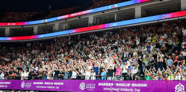 (260813) -- HAIKOU, Aug. 13, 2026 (Xinhua) -- Audiences cheer for Team China during an international basketball game at Wuyuanhe gymnasium in Haikou, south China's Hainan Province, July 27, 2026. Hainan is stepping up with efforts to build a world-class destination for international tourism and consumption as a key component of the Hainan Free Trade Port, and to probe for a new path towards high-quality development in its tourism-led consumer economy with distinctive local characteristics. 
   Hainan is projected to annually receive 154 million counts of domestic and international visits by 2030, along with tourism-related revenue of 363 billion yuan (about 53.83 billion U.S. dollars). (Xinhua/Yang Guanyu)
