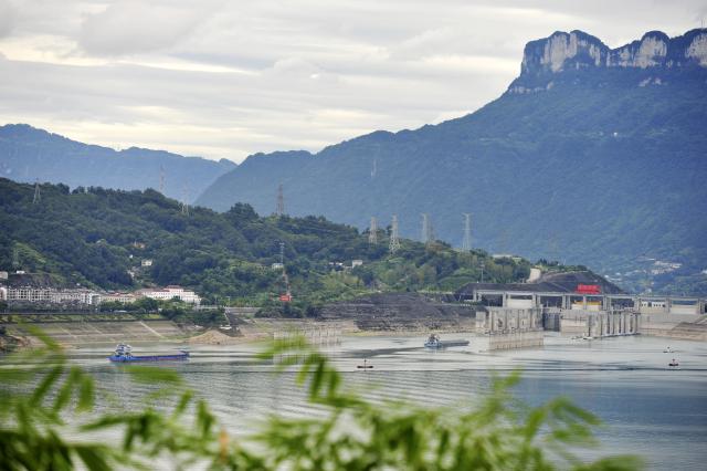 (260813) -- ZIGUI, Aug. 13, 2026 (Xinhua) -- This photo taken on Aug. 13, 2026 shows ships moving in the waters in Taipingxi in front of the Three Gorges Dam in Yichang City of central China's Hubei Province. The throughput of the Three Gorges Water Control Hub from the beginning of this year to 00:40 on Aug. 13 was estimated to reach 100 million tons. The ship locks operated 5,863 times to let through 21,562 vessels with a total throughput of 97.276 million tons; while the ship lift operated 2,557 times to move 2,590 vessels with a total of 446,000 passengers. (Photo by Wang Huifu/Xinhua)