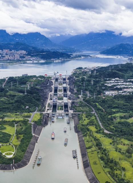 (260813) -- ZIGUI, Aug. 13, 2026 (Xinhua) -- An aerial drone photo taken on Aug. 13, 2026 shows vessels passing through the ship locks of the Three Gorges in Yichang City, central China's Hubei Province. The throughput of the Three Gorges Water Control Hub from the beginning of this year to 00:40 on Aug. 13 was estimated to reach 100 million tons. The ship locks operated 5,863 times to let through 21,562 vessels with a total throughput of 97.276 million tons; while the ship lift operated 2,557 times to move 2,590 vessels with a total of 446,000 passengers. (Photo by Zheng Jiayu/Xinhua)