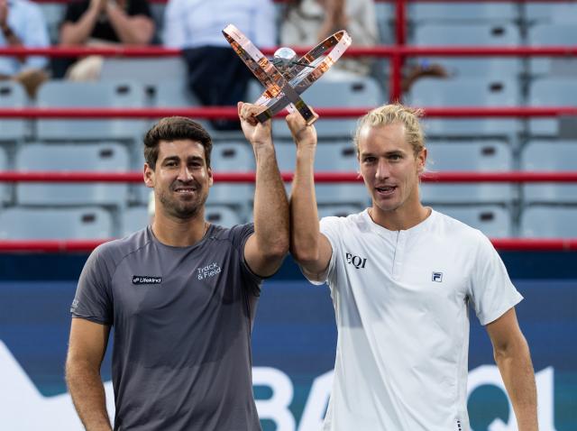 (260814) -- MONTREAL, Aug. 14, 2026 (Xinhua) -- Orlando Luz (L)/Rafael Matos celebrate with the trophy after winning the men's doubles final match between Orlando Luz/Rafael Matos of Brazil and Marcelo Arevalo (El Salvador)/Mate Pavic (Croatia) at the 2026 National Bank Open tennis tournament in Montreal, Canada, Aug. 13, 2026. (Photo by Li Haitao/Xinhua)