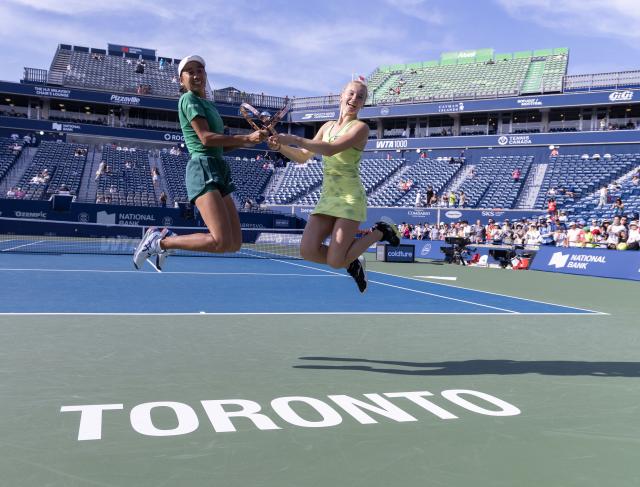 (260814) -- TORONTO, Aug. 14, 2026 (Xinhua) -- Zhang Shuai (L)/Katerina Siniakova pose for photos with the trophy during the awarding ceremony after the women's doubles final match between Zhang Shuai(China) / Katerina Siniakova(the Czech Republic) and Sara Errani(Italy)/Nicole Melichar-Martinez(the United States) at the 2026 National Bank Open tennis tournament in Toronto, Canada, Aug. 13, 2026. (Photo by Zou Zheng/Xinhua)