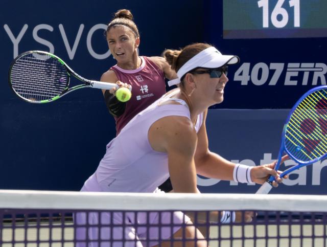 (260814) -- TORONTO, Aug. 14, 2026 (Xinhua) -- Sara Errani(back)/Nicole Melichar-Martinez compete during the women's doubles final match between Zhang Shuai(China) / Katerina Siniakova(the Czech Republic) and Sara Errani(Italy)/Nicole Melichar-Martinez(the United States) at the 2026 National Bank Open tennis tournament in Toronto, Canada, Aug. 13, 2026. (Photo by Zou Zheng/Xinhua)
