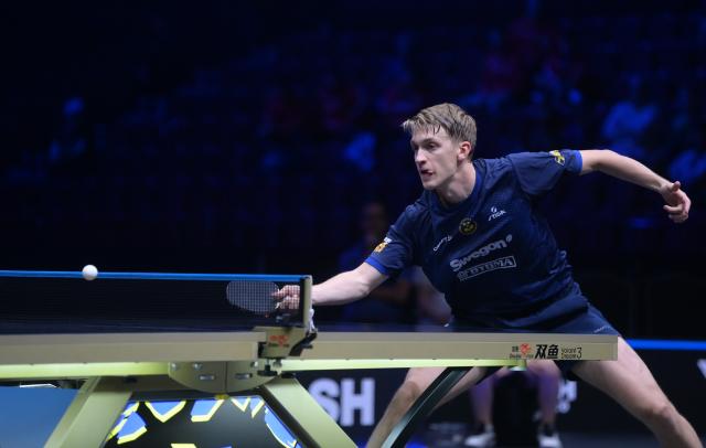 (260814) -- MALMO, Aug. 14, 2026 (Xinhua) -- Anton Kallberg hits a return during the men's singles round of 32 match between China's Zhou Qihao and Sweden's Anton Kallberg at the WTT Europe Smash Sweden 2026 in Malmo, Sweden, Aug. 13, 2026. (Xinhua/Weng Xinyang)
