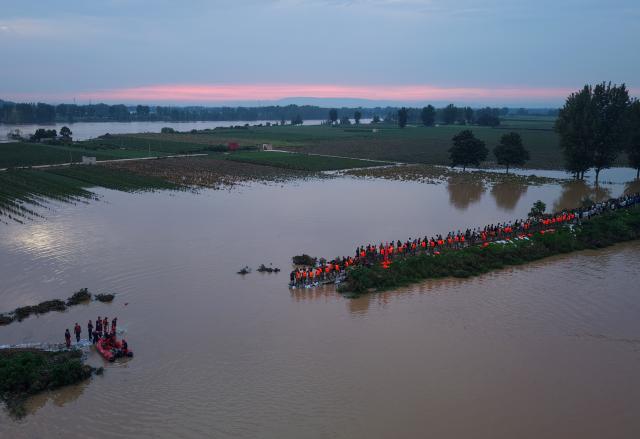 (260814) -- JIAXIAN, Aug. 14, 2026 (Xinhua) -- An aerial drone photo shows repair work underway at the site of a levee breach along the Beiru River in Jiaxian County, central China's Henan Province, Aug. 13, 2026.
  A levee along the Beiru River in Jiaxian County gave way on Wednesday night, following extreme rainfall and large-volume discharges from upstream reservoirs.
  As of Thursday, a total of 2,182 people had been evacuated to safety, with no casualties reported so far. Efforts to contain the levee breach are underway. (Xinhua/Hao Yuan)