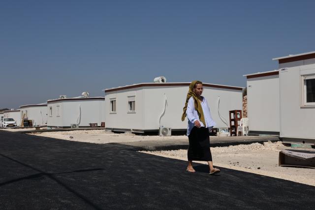 (260814) -- JERUSALEM, Aug. 14, 2026 (Xinhua) -- A Jewish settler walks past a prefabricated house in the West Bank settlement of Ganim on Aug. 13, 2026.
  Four settlements in the West Bank, including Ganim, were evacuated in 2005 as part of Israel's "Disengagement Plan". The Ganim settlement has now been re-established, 21 years after its evacuation. (Photo by Gil Cohen Magen/Xinhua)