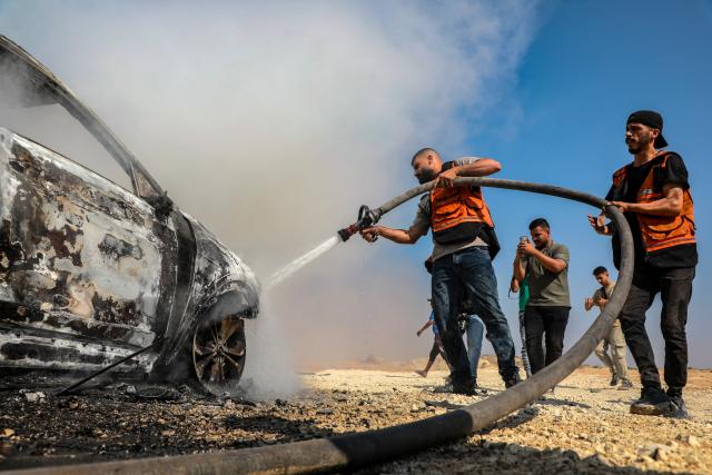 (260814) -- GAZA, Aug. 14, 2026 (Xinhua) -- Palestinian firefighters try to extinguish a fire that broke out in a vehicle carrying Gaza Police Chief Jamal Mahmoud Abu Kamil after it was targeted by an Israeli airstrike on Rashid Street, southwest of Gaza City, on Aug. 13, 2026. The Hamas-run interior authorities in the Gaza Strip said on Thursday that the 43-year-old Gaza Police Chief Jamal Mahmoud Abu Kamil was killed in an Israeli airstrike that targeted his vehicle on Rashid Street, southwest of Gaza City. (Photo by Rizek Abdeljawad/Xinhua)