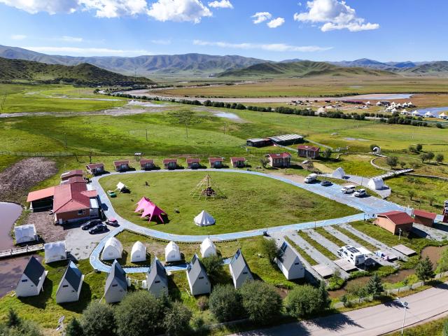 (260814) -- ABA, Aug. 14, 2026 (Xinhua) -- An aerial drone photo taken on Aug. 13, 2026 shows a view of RV camp hotels in Hongyuan County, Aba Tibetan and Qiang Autonomous Prefecture, southwest China's Sichuan Province. In recent years, Aba Tibetan and Qiang Autonomous Prefecture has leveraged its rich plateau resources to promote the development of agriculture and tourism, injecting new impetus into rural revitalization here. (Xinhua/Wang Xi)