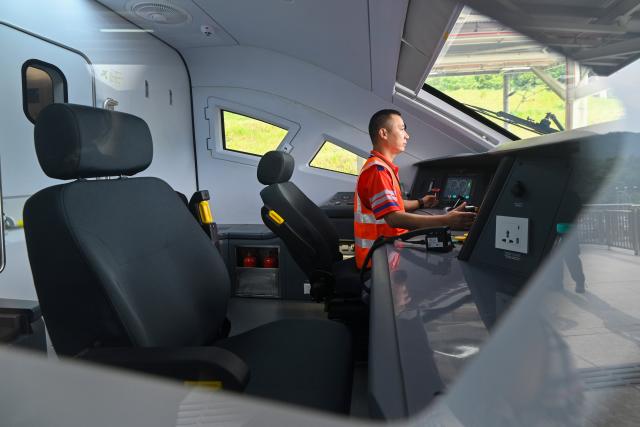 (260814) -- SELANGOR, Aug. 14, 2026 (Xinhua) -- A staff member runs tests aboard a train at the Gombak station of the East Coast Rail Link (ECRL) in Selangor state, Malaysia, Aug. 14, 2026. The East Coast Rail Link (ECRL), a mega rail project in Malaysia being built by the China Communications Construction Company (CCCC), is expected to begin commercial operations by January 2027, Transport Minister Anthony Loke Siew Fook said on Friday.
  In the meantime, the railway has reached 95.08 percent overall progress and has entered its testing and commissioning phase, keeping with its project schedule, Loke said in his speech at the launch ceremony of the ECRL Comprehensive Inspection Train (CIT). (Photo by Chong Voon Chung/Xinhua)