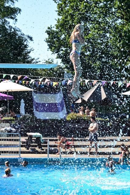 (260814) -- DELDEN, Aug. 14, 2026 (Xinhua) -- A woman jumps into an outdoor swimming pool in Delden, the Netherlands, Aug. 14, 2026. The Royal Netherlands Meteorological Institute (KNMI) issued a yellow heat warning on Aug. 14, 2026, as temperatures reached 35 degrees Celsius, marking the fifth heatwave in the Netherlands this year. (Photo by Eric Brinkhorst/Xinhua)