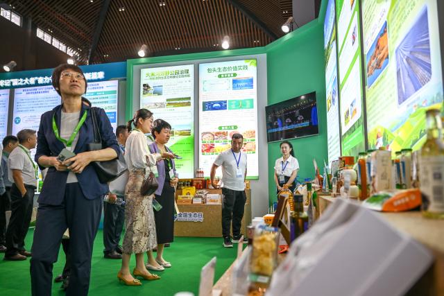 (260815) -- HULUNBUIR, Aug. 15, 2026 (Xinhua) -- Visitors view exhibits during a main event of the fourth National Ecology Day in Hulunbuir, north China's Inner Mongolia Autonomous Region, Aug. 15, 2026.
  China's top legislature designated Aug. 15 as National Ecology Day in 2023 to raise public awareness of ecological conservation and encourage action to protect the environment. (Xinhua/Lian Zhen)