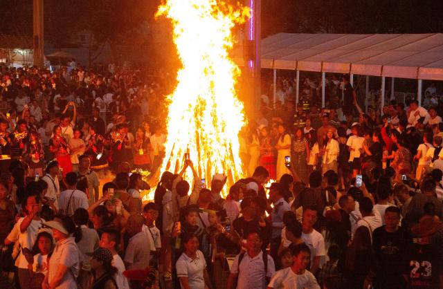 (260815) -- CHENGDU, Aug. 15, 2026 (Xinhua) -- People dance around the bonfire in Xichang, Liangshan Yi Autonomous Prefecture, southwest China's Sichuan Province, Aug. 8, 2026.
  TO GO WITH "China Focus: Torch Festival flames light up more benefits in SW China" (Xinhua)