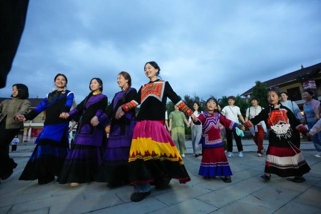 (260815) -- CHENGDU, Aug. 15, 2026 (Xinhua) -- Tourists and locals dance to celebrate the Torch Festival in Yihai Village of Mianning County, southwest China's Sichuan Province, July 29, 2026.
  TO GO WITH "China Focus: Torch Festival flames light up more benefits in SW China" (Xinhua/Xu Bingjie)